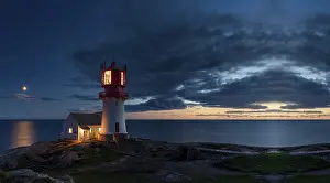 Coastal Region Photography Prints: Lighthouse surrounded by rocks at night