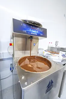 Central Europe Grocery Store Prints: Liquid chocolate flows out of a chocolate machine in a kitchen