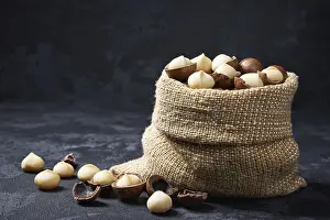 Macadamia Nuts Prints: Macadamia nuts in a bag on a black table