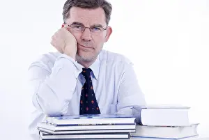 Office Worker Photo Prints: Man, 50+, leaning on a stack of books
