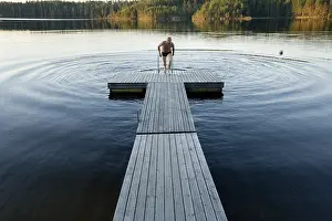 Athletic Male Figure Prints: Man climbing onto dock