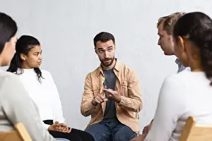 Group Therapy Session Prints: Man explaining his problems group therapy session