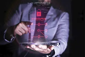 Cyber Crime Prevention Prints: A man interacts with a virtual error message related to security on a transparent digital device