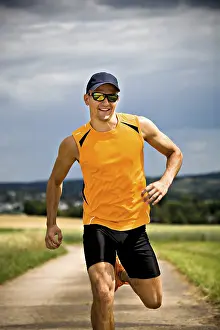 Athletic Man Prints: Man jogging through the fields