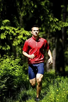 Recreational Activity Man Prints: Man jogging in forest