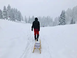 Snow Capped Mountain Landscape Prints: Man pulling a sledge through the snow