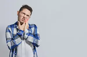 Male Portrait Photo Prints: Man suffering with toothache or pulpitis