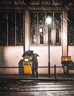 Central Europe Winter Scene Prints: Man with umbrella in snow in front of mailboxes
