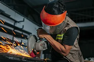 Handicraft Industry Prints: Man using a grinder in a workshop