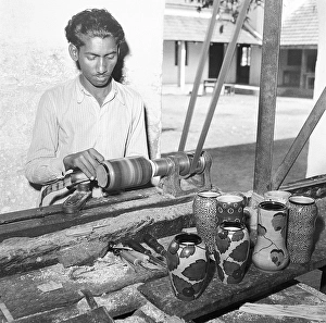 Metal Working Machinery Prints: Man using portable rotating lathe