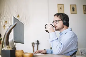 Modern Office Architecture Prints: Man working computer drinking