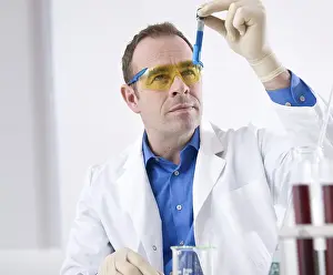 Chemistry Experiment Prints: Man working on an experiment in a laboratory