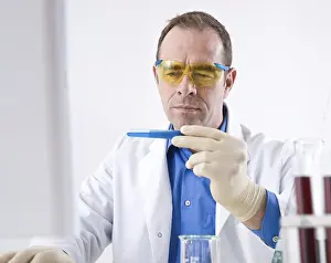 Chemistry Experiment Prints: Man working on an experiment in a laboratory