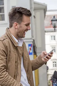 Mobile Phone Communication Prints: A man writes a text message on his mobile phone