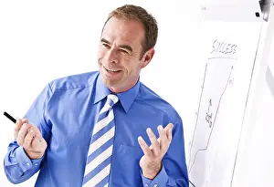 Business Executive Prints: Manager smiling, standing in front of a flipchart