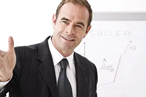 Middle Aged Man Prints: Manager standing in front of a flipchart