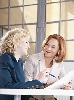 Office Teamwork Success Prints: Manager working in an office with a trainee