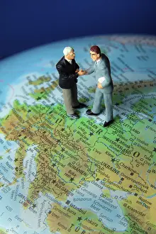 Business Executives Prints: Two managers on one globe. Globalisation