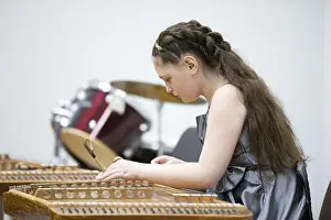 Prints of May 21, 2021 Belarus. city of Gomil. Holiday at the music school.The girl plays the ethnic instrument dulcimer Belarus Prints: Belarus, Gomel: Holiday at the Music School Print