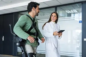 Healthcare Innovation Technology Prints: Mechanical exoskeleton, female doctor physiotherapist with disabled person with robotic skeleton in rehabilitation