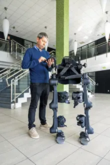 Robotic Skeleton Technology Prints: Mechanical exoskeleton computer engineer looking at the robot with a tablet