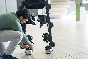 Exoskeleton Technology Prints: Mechanical exoskeleton engineer checking robot before delivery to customer