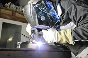 Construction Industry Images Prints: Metal worker during welding work