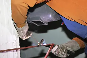 Industrial Equipment Prints: Metal worker during welding work