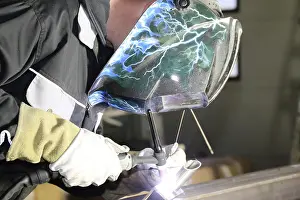 Protective Clothing For Workers Prints: Metalworker during welding work in his workshop