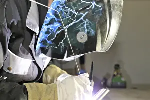 Construction Site Worker Prints: Metalworker during welding work in his workshop