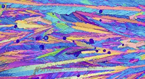 Prints of Microscopic image of Adipic acid, crystals in hues of pink, blue, yellow, and green. The image highlights the textured, abstract appearance of the crystals, enhanced by polarized light Polarized Light Prints: Polarized Microscopic Print of Adipic Acid Crystals