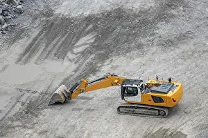 Construction Machinery Images Prints: Mining in the granite quarry. Working mining machine
