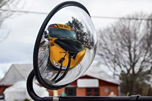 Deserted Public Transport Prints: Mirroring of the yellow schoolbus on its own external mirror