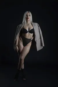 Fashionable Outfit Prints: A model stands confidently in a dark studio