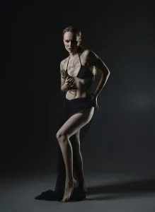 Confident Model Pose Prints: A model stands confidently in a dark studio