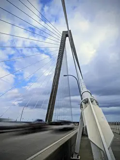 Contemporary Architectural Style USA Prints: A modern cable-stayed bridge under a partly cloudy sky