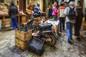 Historic Old Town Center Prints: Moped parked between boxes, anonymous crowd in souk