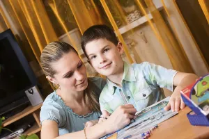 Child Learning At Home Prints: Mother and boy doing homework together and posing