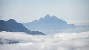 Overcast Sky Photography Prints: Mountain peaks above the clouds