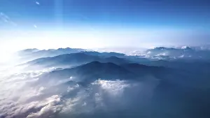 Himalayan Mountains Prints: Mountain range above clouds under a blue sky