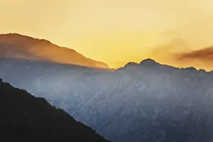 Mountain Sunset Prints: Mountain sunset and colored sky with clouds