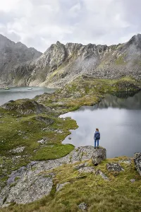 Mountaineer on a rock in front of mountain lakes Wangenitzsee and Kreuzsee