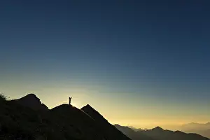 Ammergau Alps Prints: Mountaineer on summit ridge with backlight