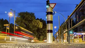 Road Safety In Europe Prints: Moving trams at an intersection with a speed camera column