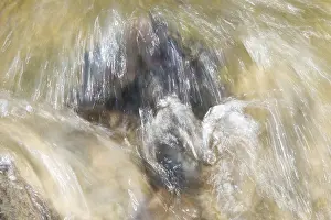 Long Exposure Water Flow Prints: Moving water flows over a boulder