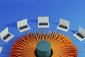 Modern Workspace Prints: Multiple laptops surround a central data hub