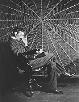 Nikola Tesla Prints: Nikola Tesla Reads in Front of a Giant Spiral Coil, 20 May 1896 Print
