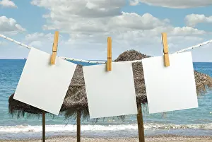 Empty Shoreline Image Prints: Note papers hooked on a rope. Beach background