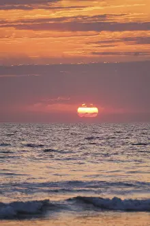 Red Sunset Background Prints: Ocean waves on sunset with setting sun background