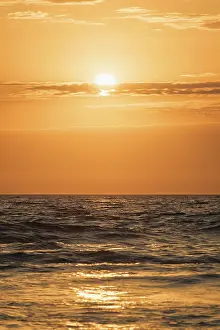 Red Sunset Background Prints: Ocean waves on sunset with setting sun background